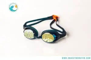 swim goggles with mirrored lens on flat surface