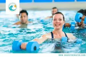 a woman uses aqua dumbbells in an aqua aerobic classes