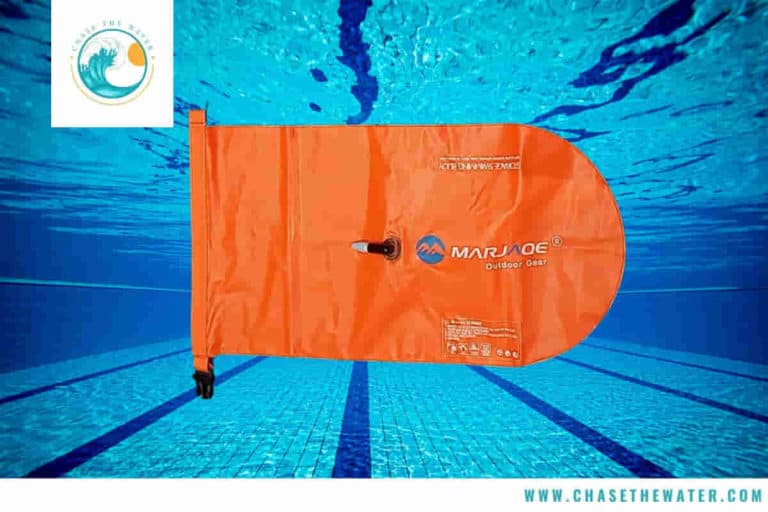 A waterproof swim bag with a pool in the background