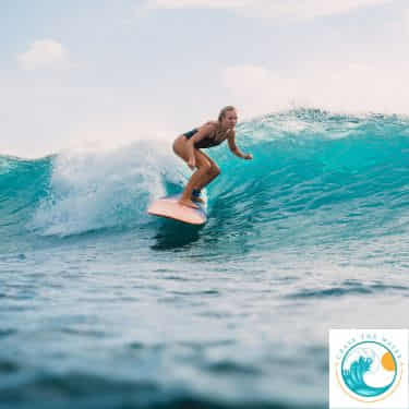 a female surfer steers her board